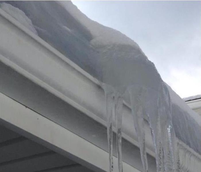 icicles hanging from edge of roof
